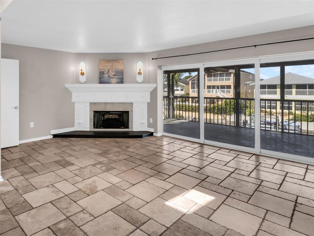 6241 Bayside Drive New Port Richey, FL 34652 - Photo 10 of 78 a view of empty room with wooden floor and fireplace