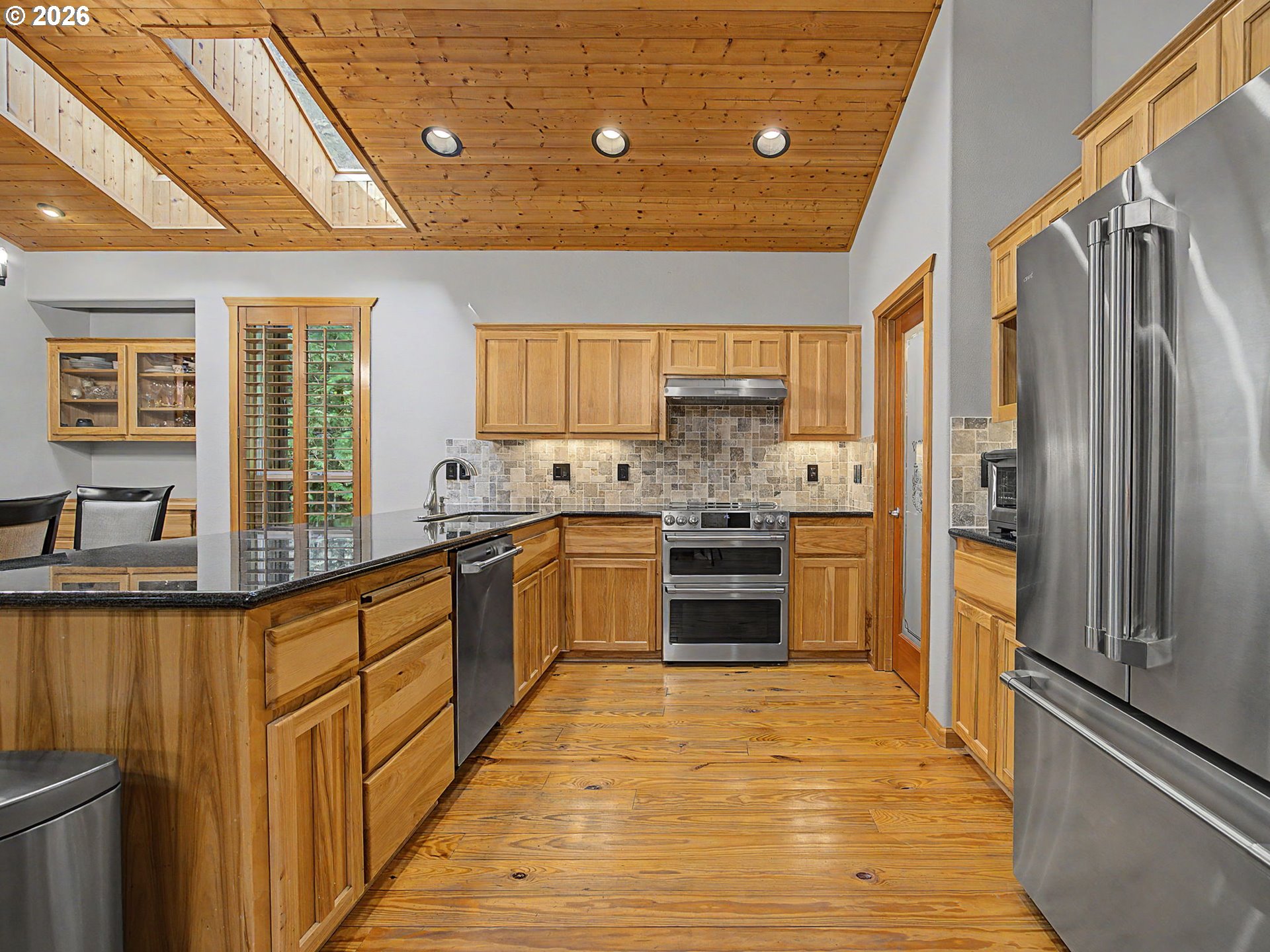 23491 East Lolo Pass Road Rhododendron, OR 97049 - Photo 18 of 47 a kitchen with stainless steel appliances granite countertop a refrigerator a sink dishwasher a stove with wooden cabinets and floor