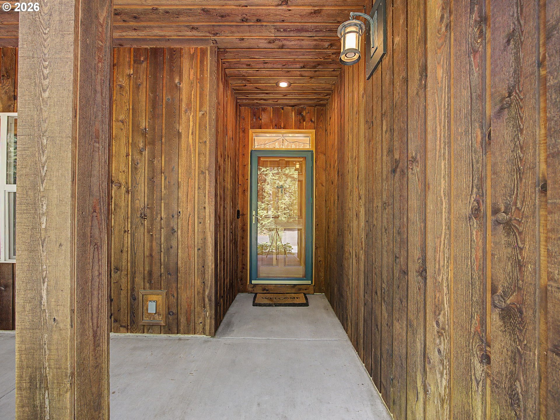23491 East Lolo Pass Road Rhododendron, OR 97049 - Photo 6 of 47 a view of a hallway with wooden shelves