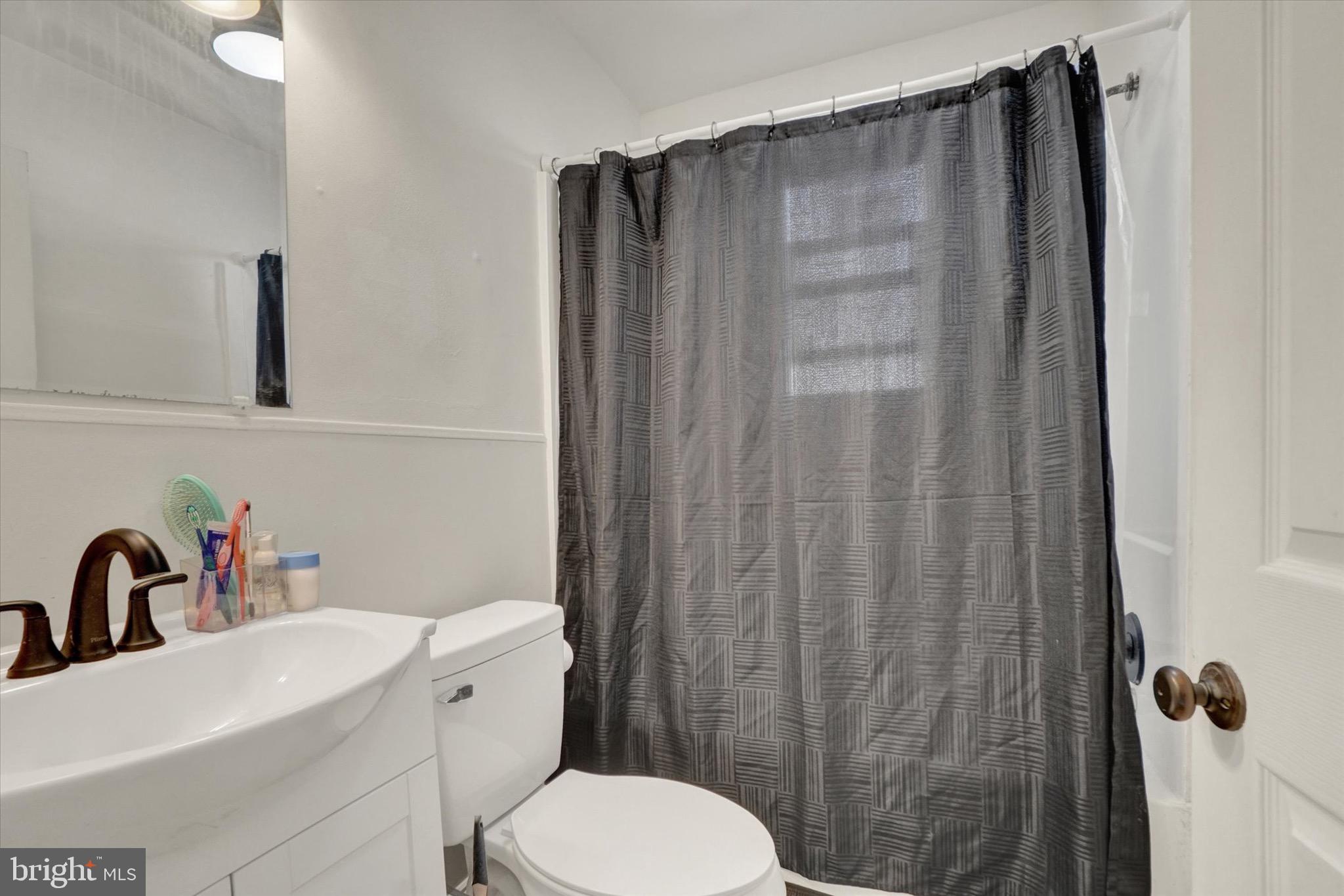 1305 Lancaster Avenue York, PA 17403 - Photo 11 of 18 a bathroom with a sink a toilet and shower curtain