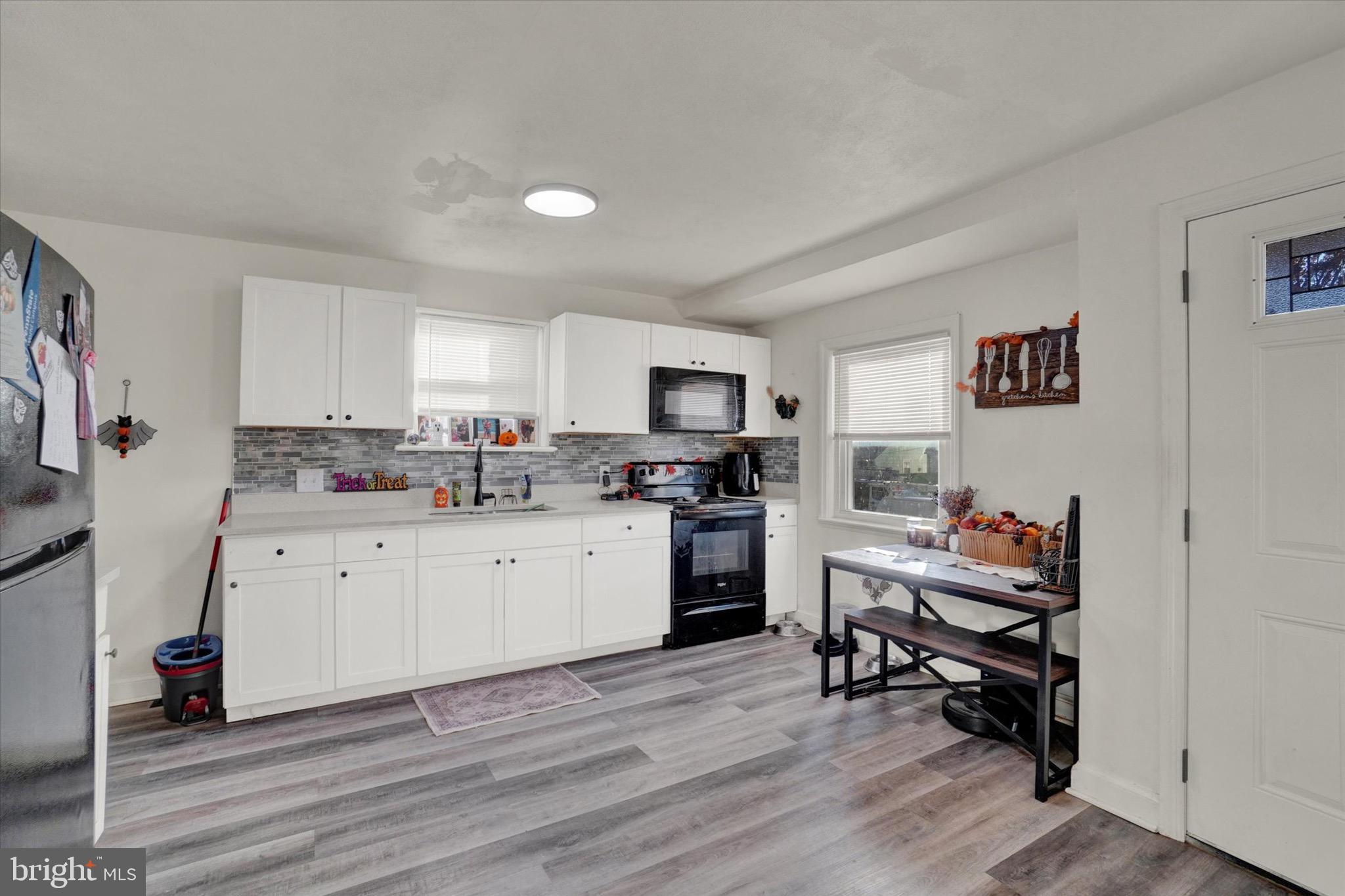 1305 Lancaster Avenue York, PA 17403 - Photo 4 of 18 a kitchen with a sink cabinets and wooden floor