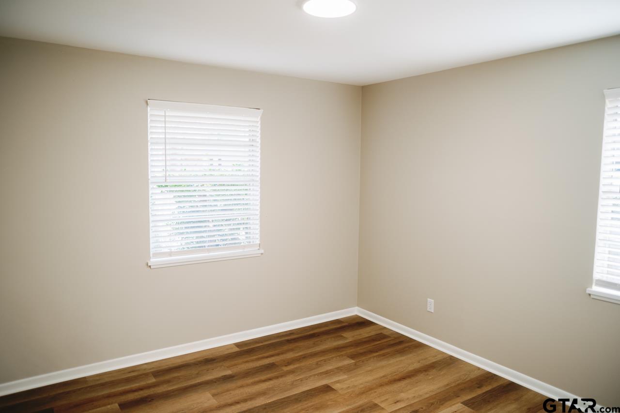 3131 Greg Lane Tyler, TX 75701 - Photo 1 of 47 an empty room with wooden floor and a window