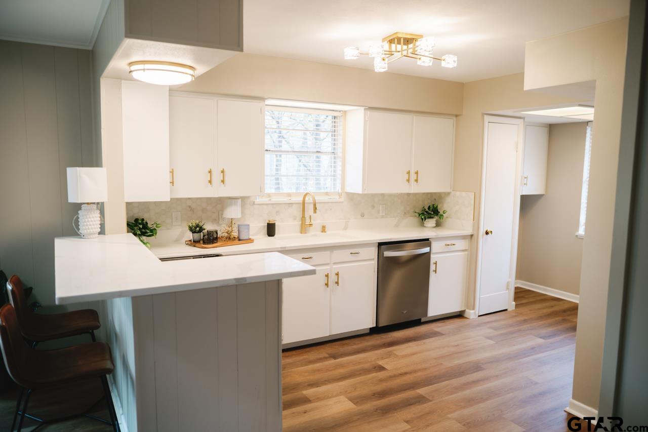 3131 Greg Lane Tyler, TX 75701 - Photo 15 of 47 a kitchen with a sink cabinets and wooden floor