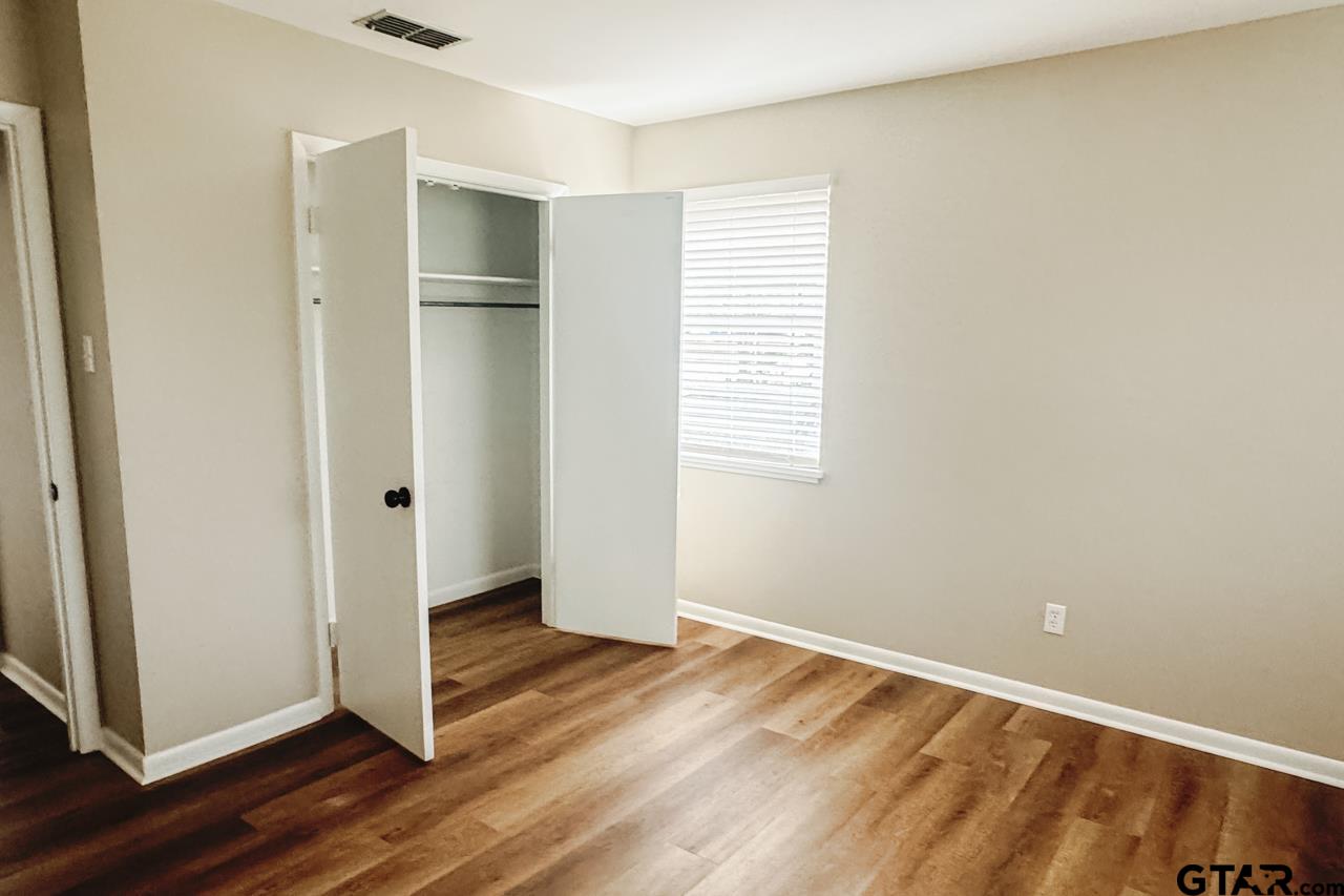 3131 Greg Lane Tyler, TX 75701 - Photo 19 of 47 an empty room with wooden floor and window