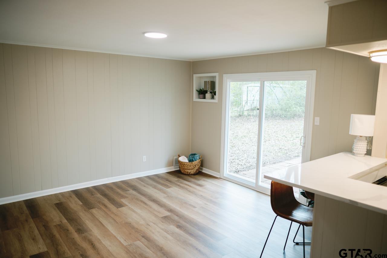 3131 Greg Lane Tyler, TX 75701 - Photo 23 of 47 a bedroom with a bed and wooden floor
