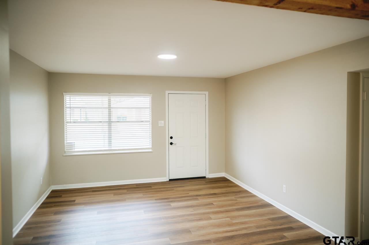 3131 Greg Lane Tyler, TX 75701 - Photo 32 of 47 an empty room with wooden floor and windows