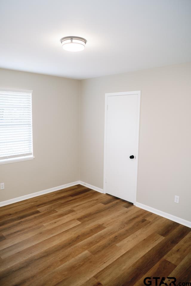 3131 Greg Lane Tyler, TX 75701 - Photo 34 of 47 a view of an empty room with wooden floor and a window
