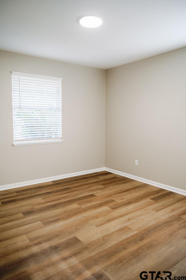 3131 Greg Lane Tyler, TX 75701 - Photo 35 of 47 a view of an empty room with wooden floor and a window