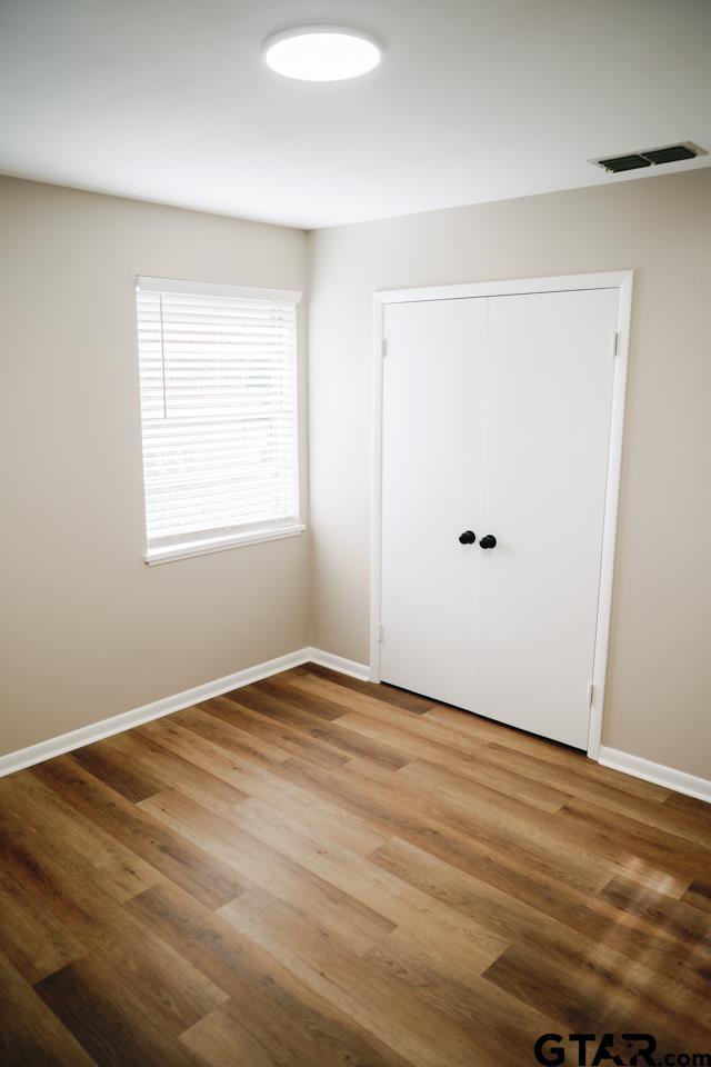 3131 Greg Lane Tyler, TX 75701 - Photo 36 of 47 a view of an empty room with wooden floor and a window