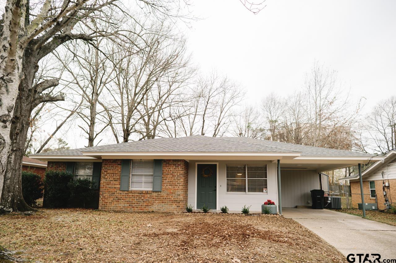 3131 Greg Lane Tyler, TX 75701 - Photo 43 of 47 a front view of a house with a yard and potted plants