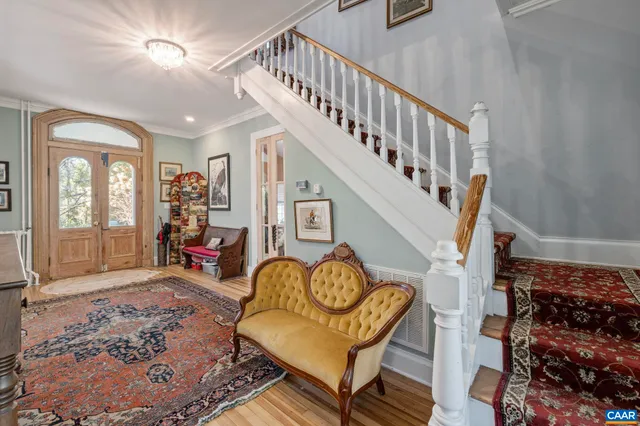 a room with lots of wooden furniture and glass door