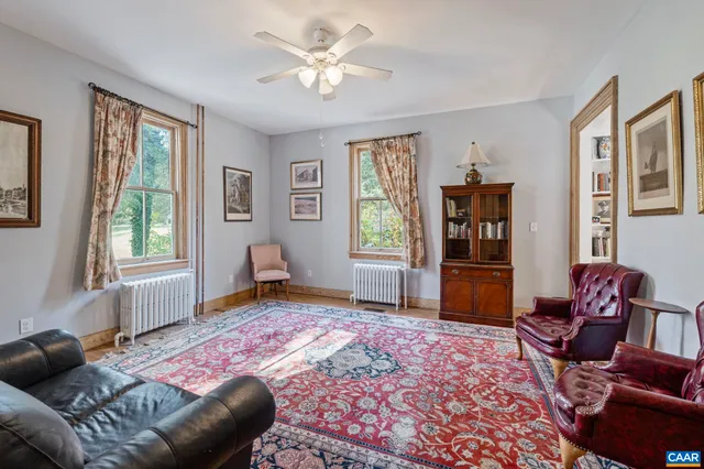 a spacious bedroom with a bed and wooden floor
