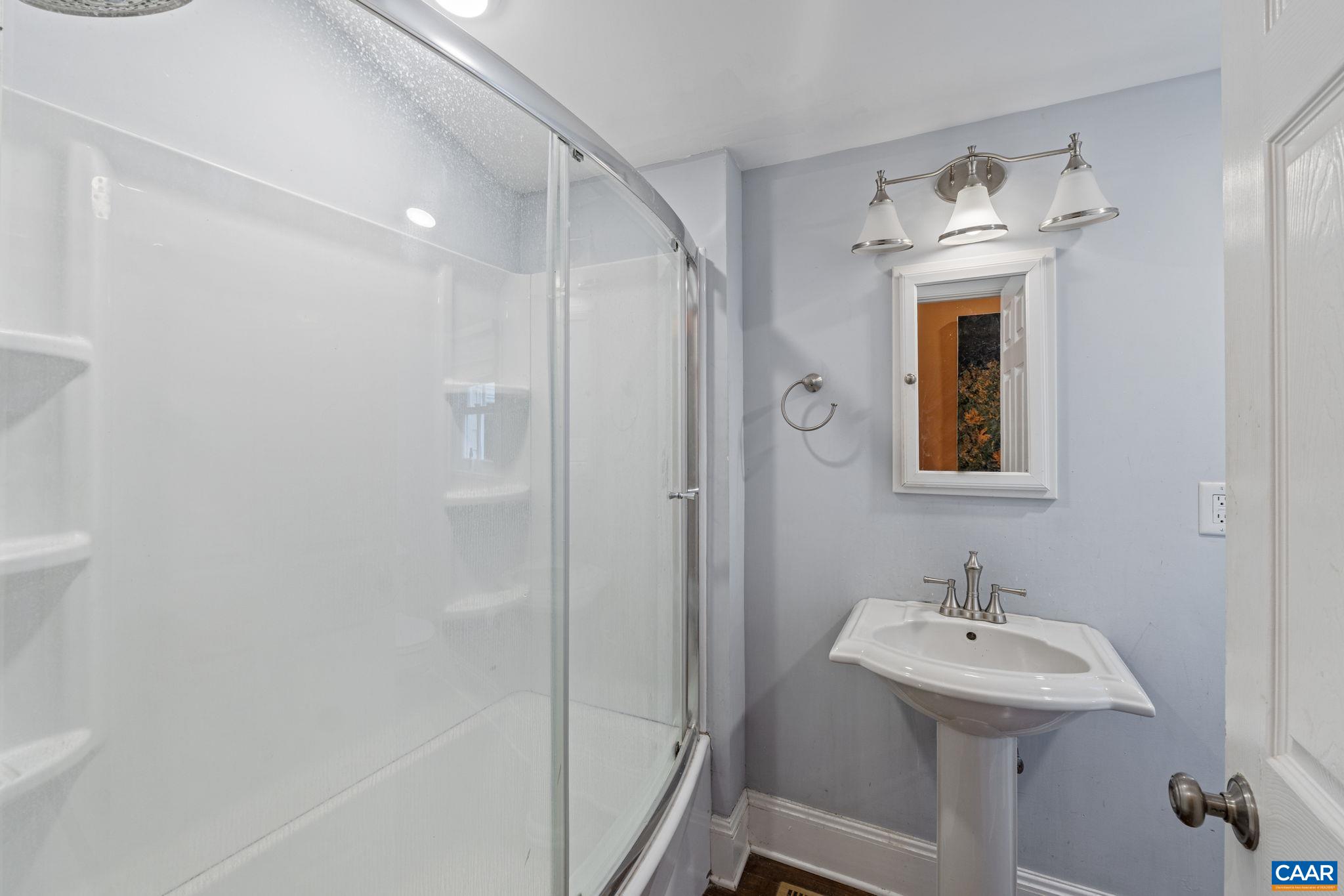 5515 Gordonsville Road Keswick, VA 22947 - Photo 30 of 74 a bathroom with a sink a mirror and a shower