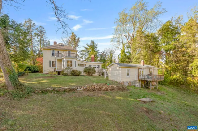 a view of a yard with plants and trees