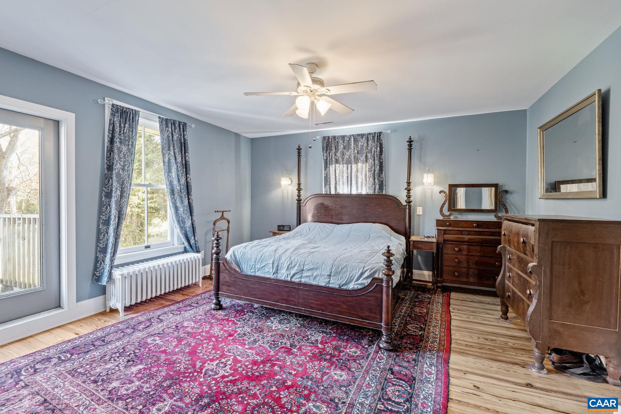 5515 Gordonsville Road Keswick, VA 22947 - Photo 34 of 74 a spacious bedroom with a bed and wooden floor