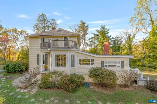 a living room with furniture a fireplace and a window