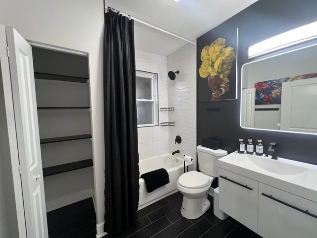 a bathroom with a toilet a sink and a mirror