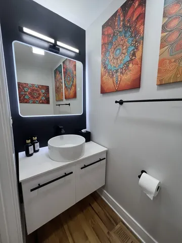 a bathroom with a sink mirror and vanity