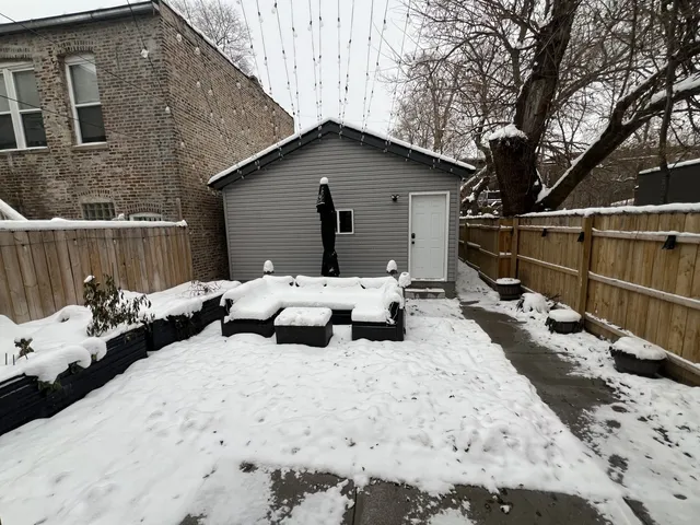 a view of a house with a yard covered in snow