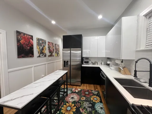 a kitchen with stainless steel appliances kitchen island sink refrigerator and stove