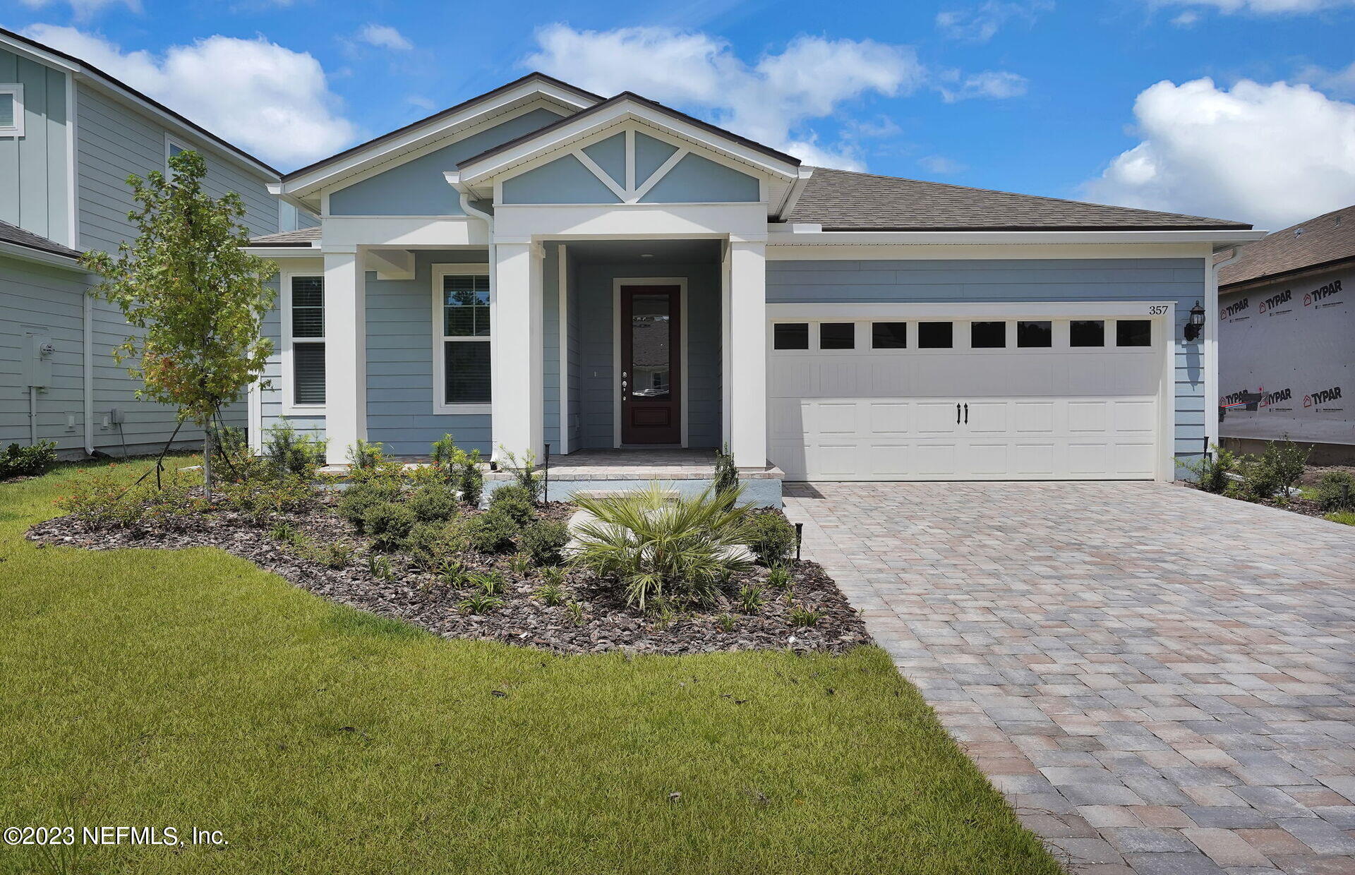 a front view of a house with a garden