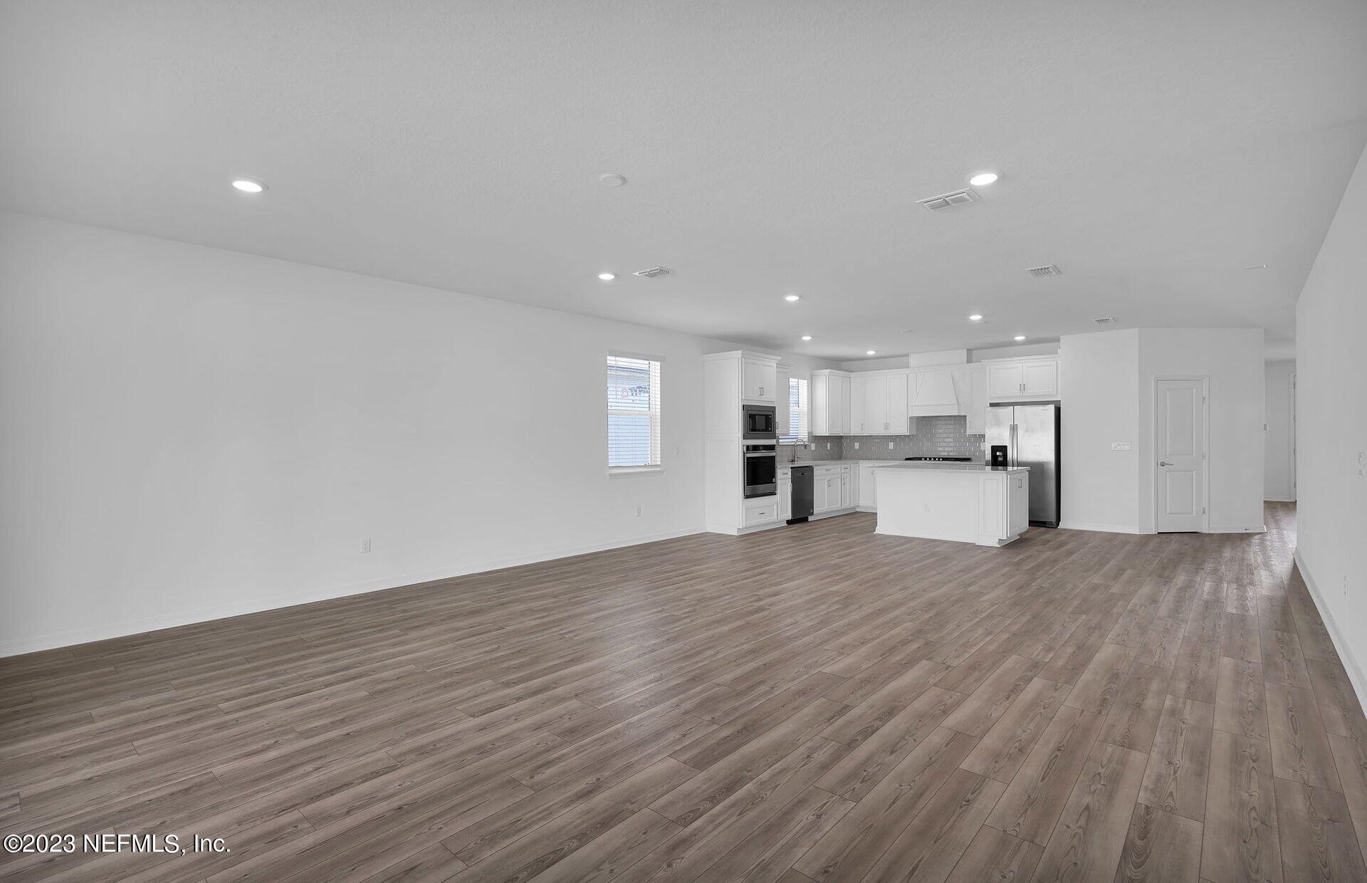 357 Muhly Grass Street Yulee, FL 32097 - Photo 11 of 20 a view of kitchen with wooden floor and kitchen appliances