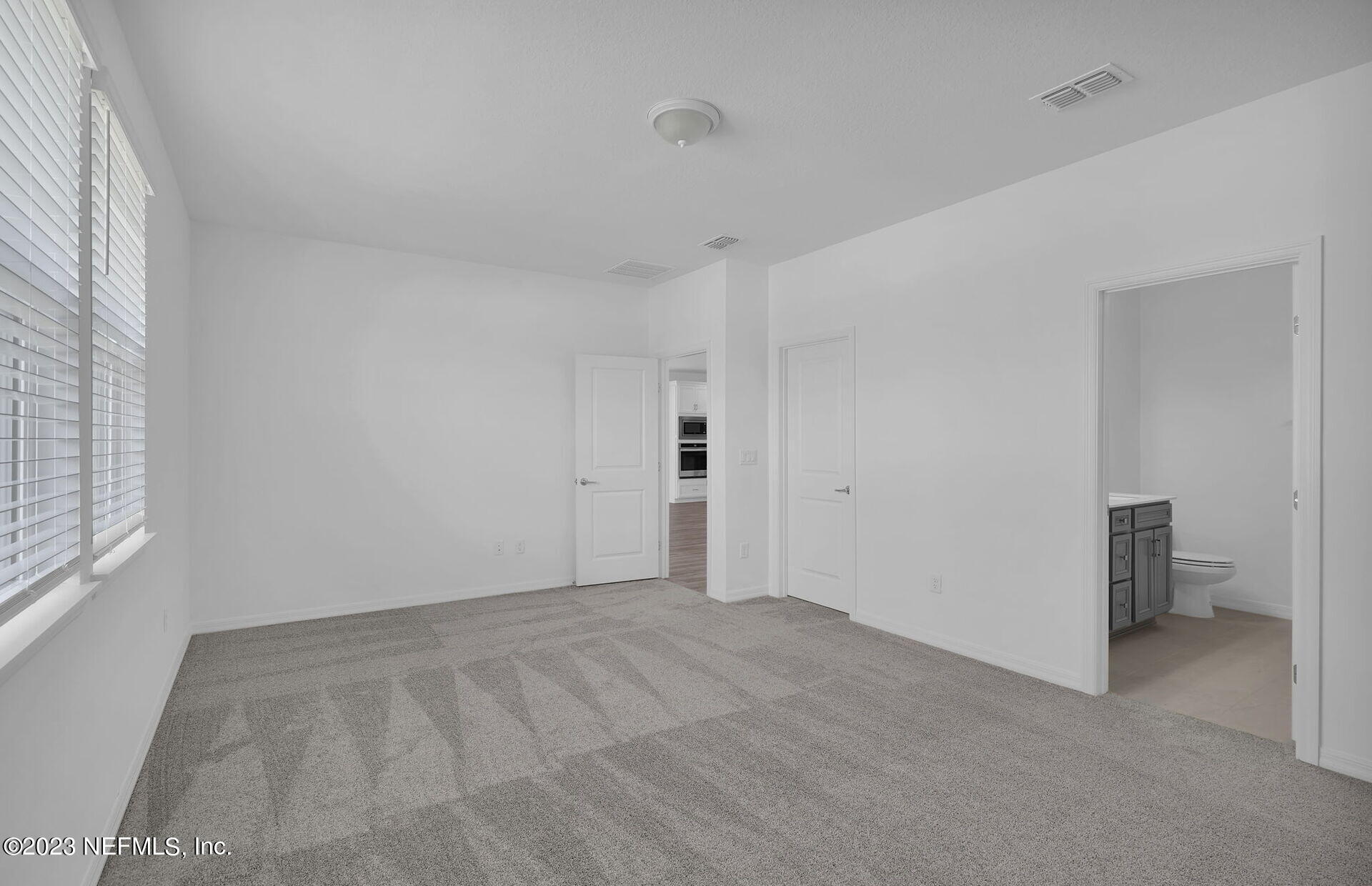 357 Muhly Grass Street Yulee, FL 32097 - Photo 12 of 20 a view of an empty room with a window