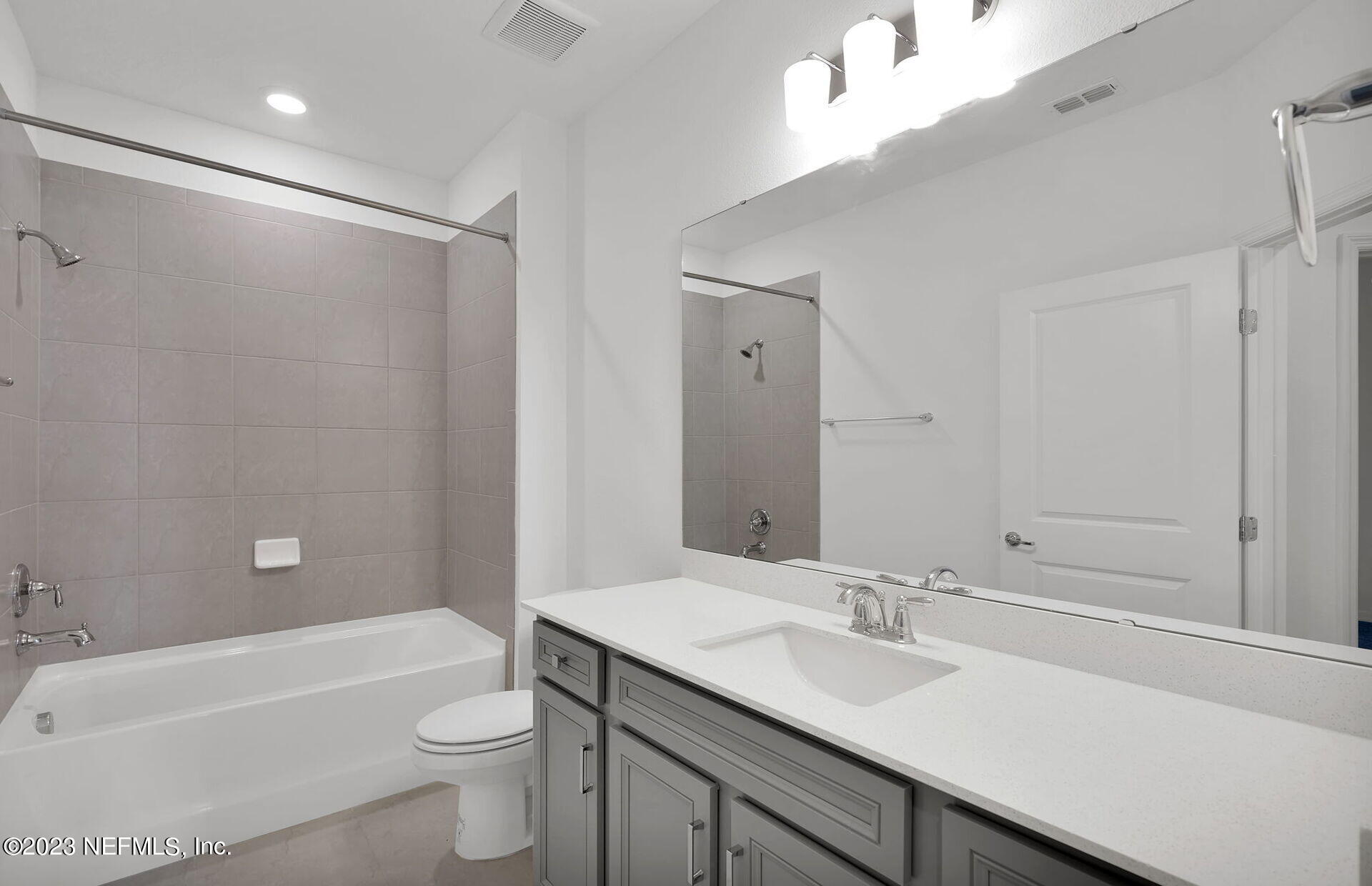 357 Muhly Grass Street Yulee, FL 32097 - Photo 17 of 20 a bathroom with a granite countertop sink toilet and shower