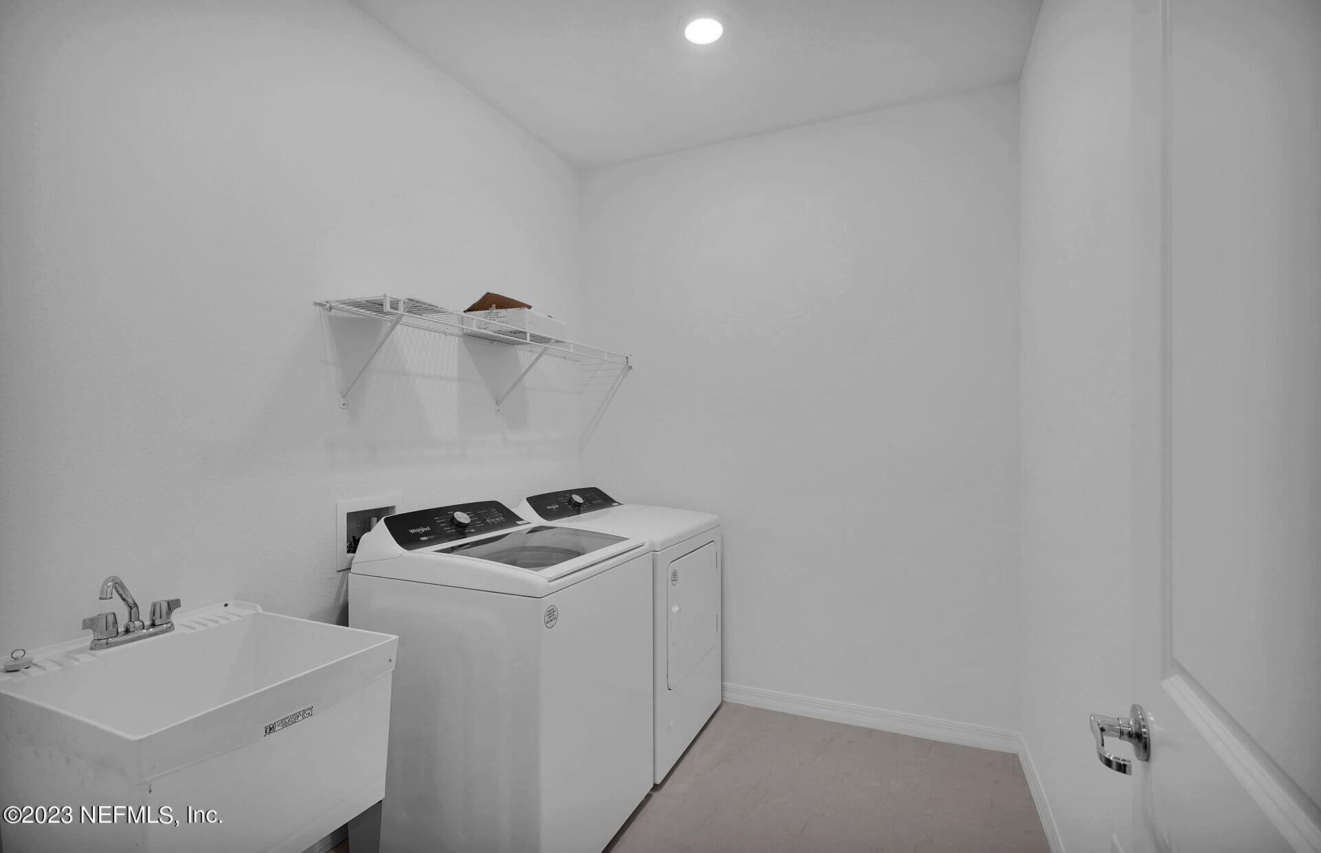 357 Muhly Grass Street Yulee, FL 32097 - Photo 19 of 20 a utility room with sink dryer and washer