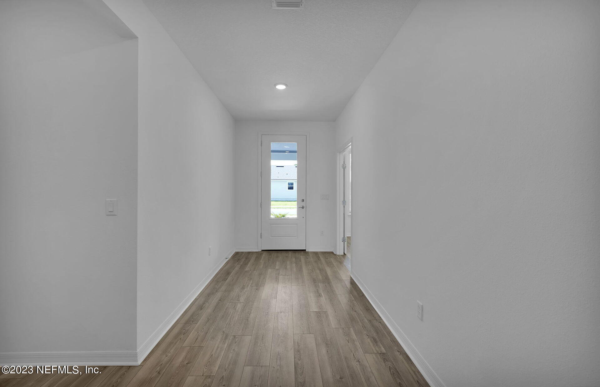 357 Muhly Grass Street Yulee, FL 32097 - Photo 3 of 20 a view of hallway with window and wooden floor