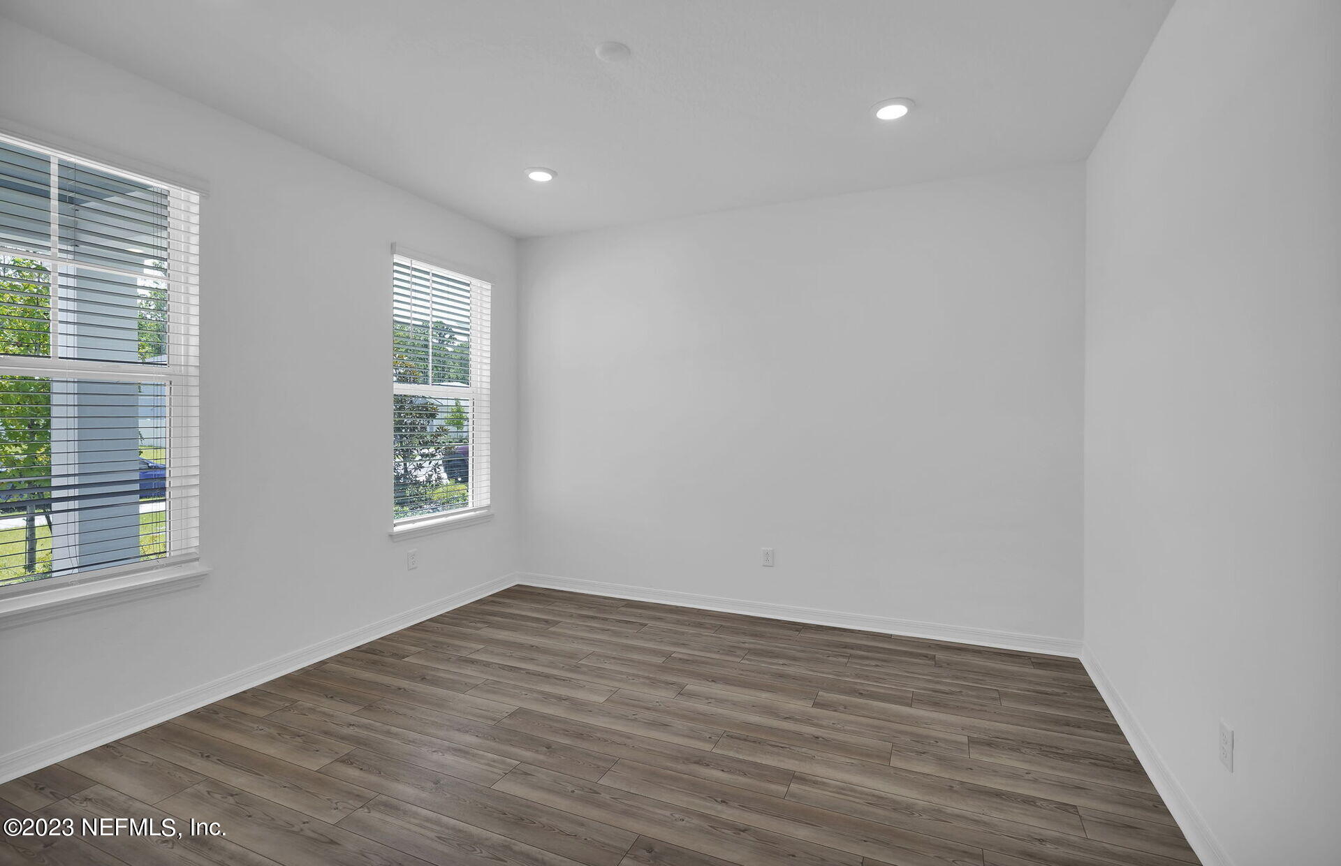 357 Muhly Grass Street Yulee, FL 32097 - Photo 4 of 20 a view of an empty room with wooden floor and a window
