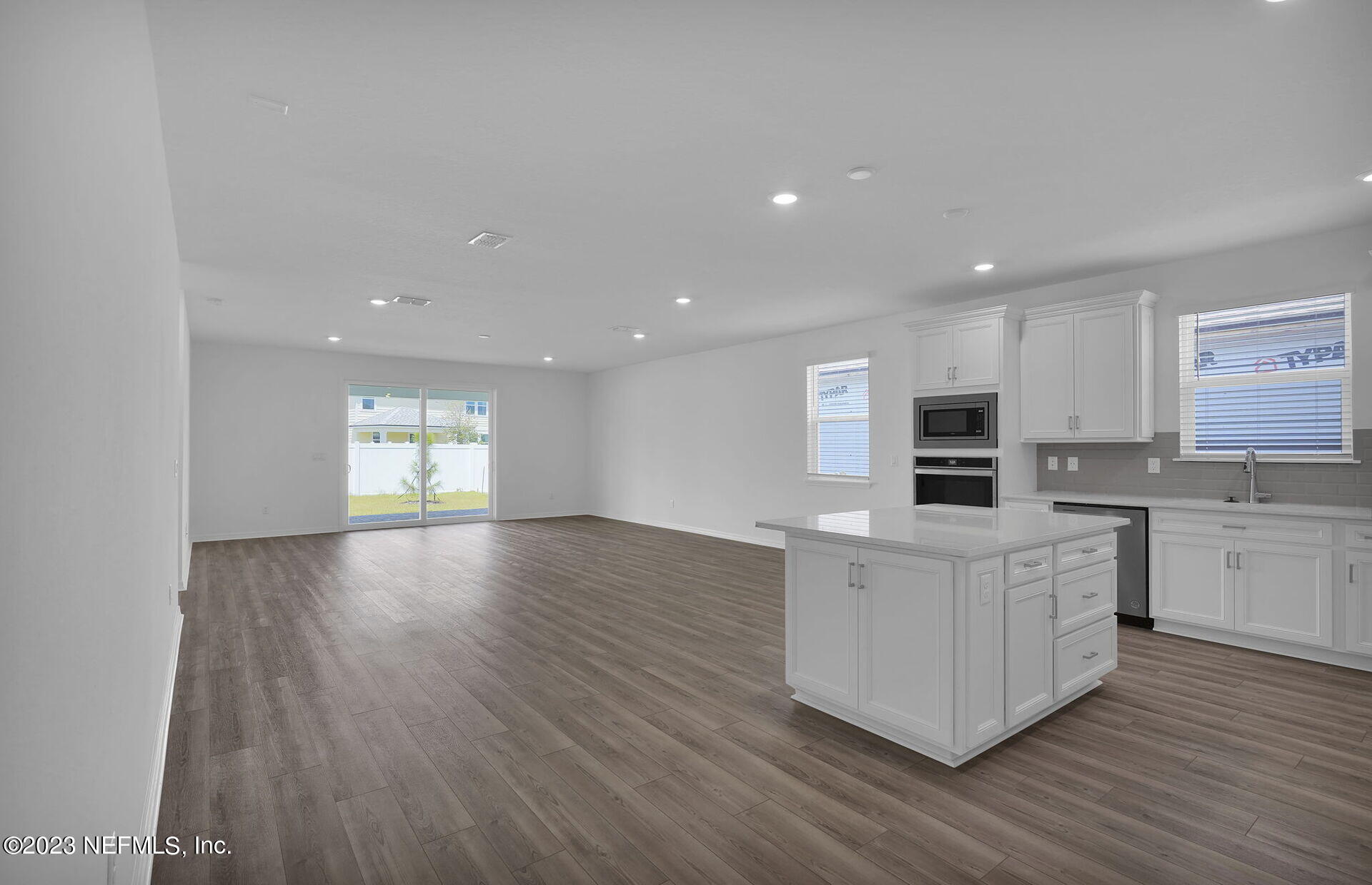 357 Muhly Grass Street Yulee, FL 32097 - Photo 5 of 20 a large kitchen with stainless steel appliances a large counter top and a stove top oven