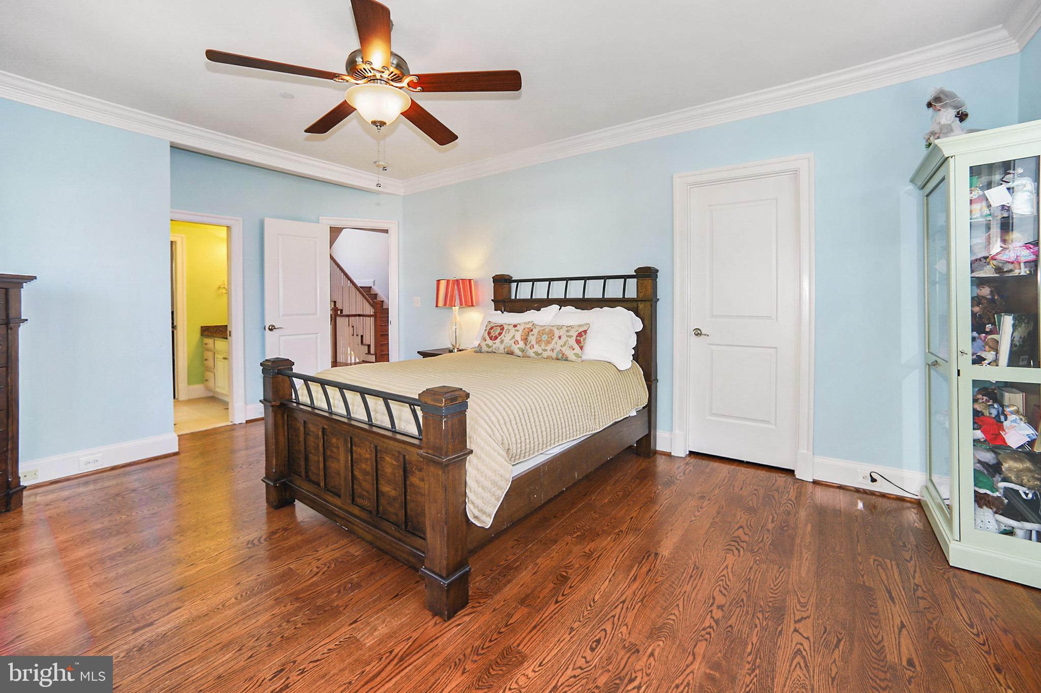 7117 Exfair Road Bethesda, MD 20814 - Photo 25 of 42 a bedroom with a bed and a chandelier
