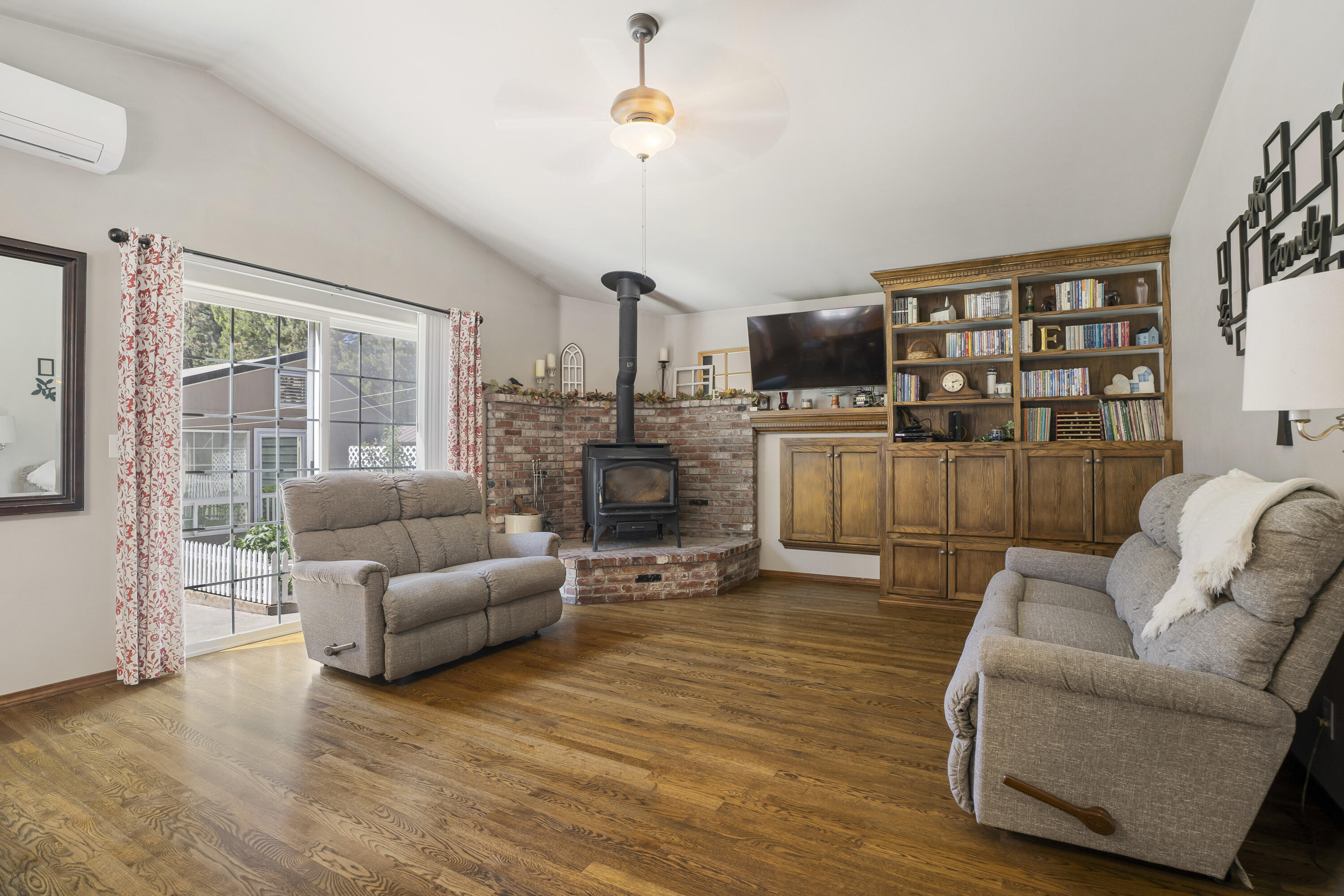 51445 Ash Road La Pine, OR 97739 - Photo 28 of 50 Family room with wood stove & exterior fire wood box. Custom built bookshelve with storage.