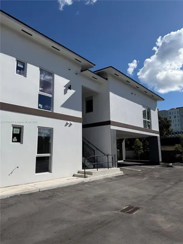 a front view of a house with a road