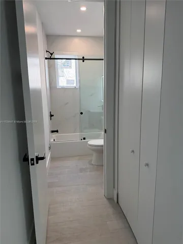 a bathroom with a shower and a glass door