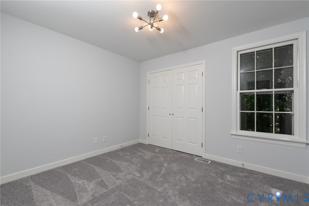 14011 Turtle Hill Road Midlothian, VA 23112 - Photo 21 of 34 an empty room with a window and a fan