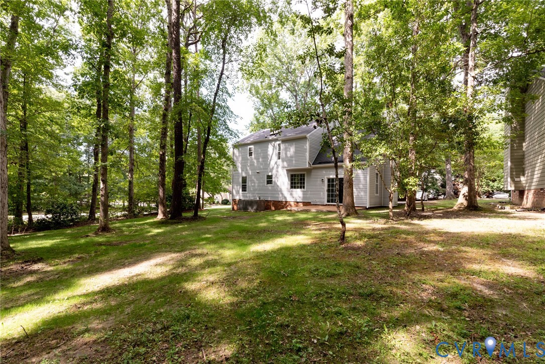 14011 Turtle Hill Road Midlothian, VA 23112 - Photo 8 of 34 a view of a house with a big yard and large trees