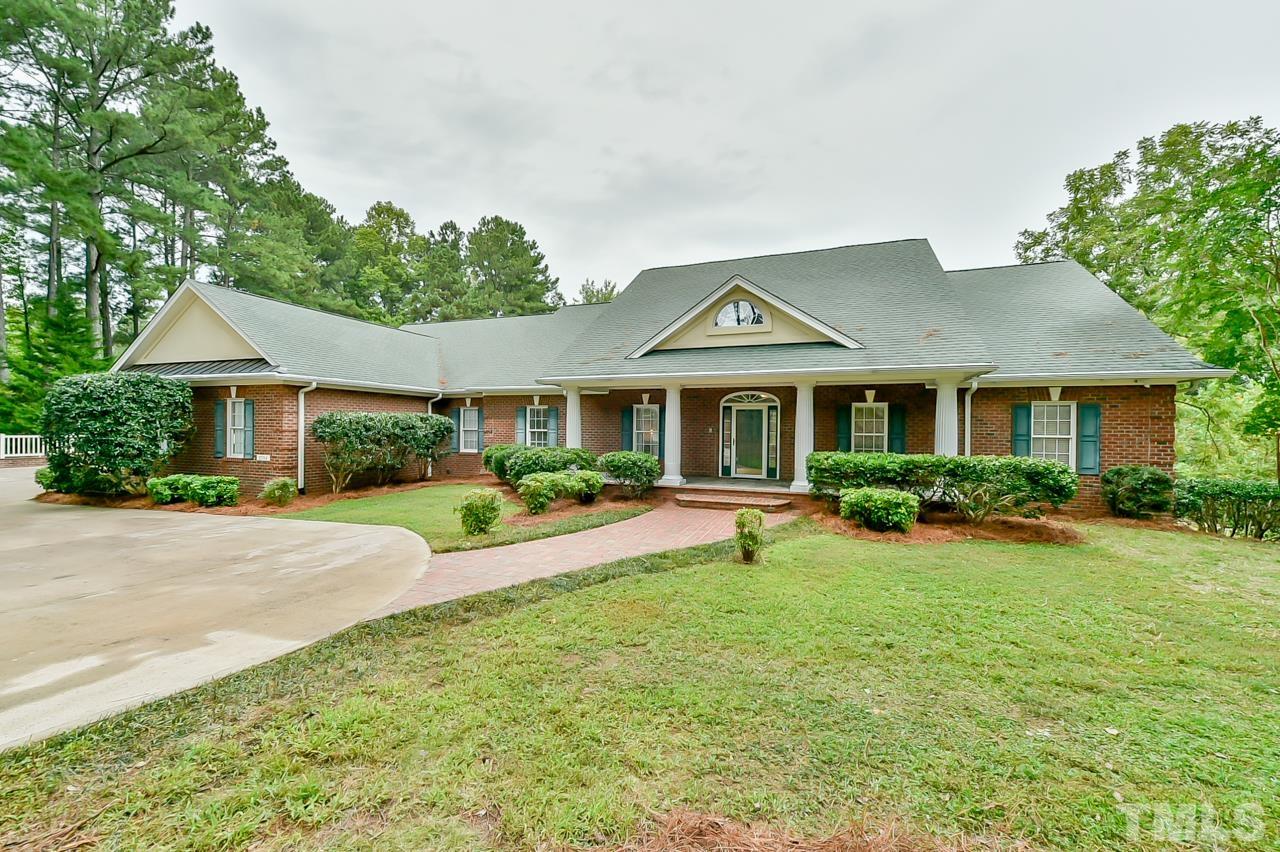 a front view of a house with yard patio and green space