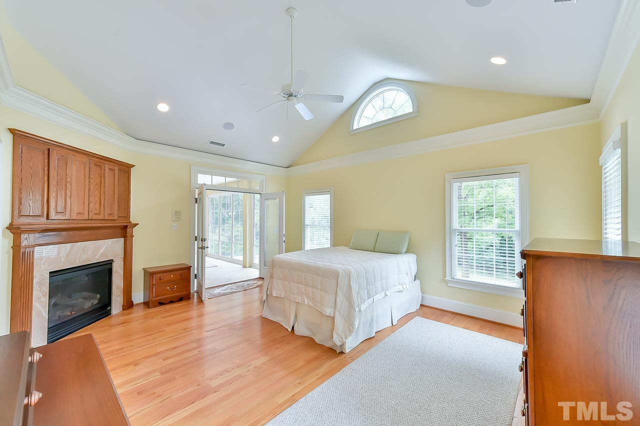 2734 River Forks Road Sanford, NC 27330 - Photo 18 of 30 a spacious bedroom with a large bed and a fireplace
