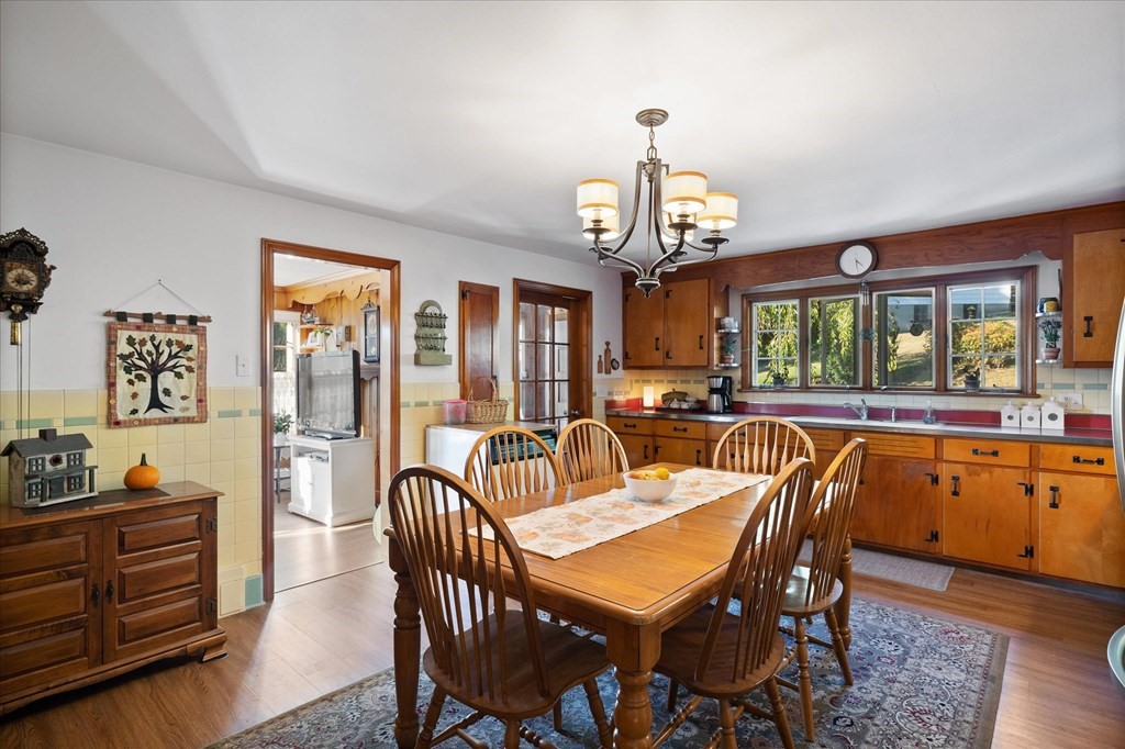 16 Main Street Sturbridge, MA 01566 - Photo 12 of 39 a view of a dining room with furniture a chandelier and wooden floor