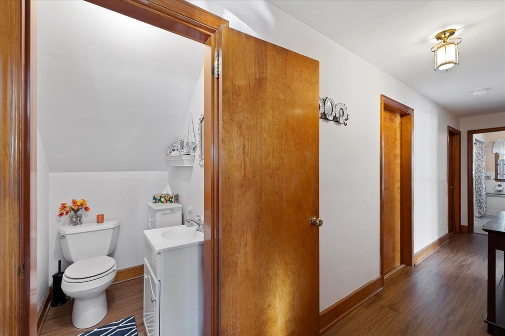 16 Main Street Sturbridge, MA 01566 - Photo 14 of 39 a bathroom with a toilet a sink and shower curtain