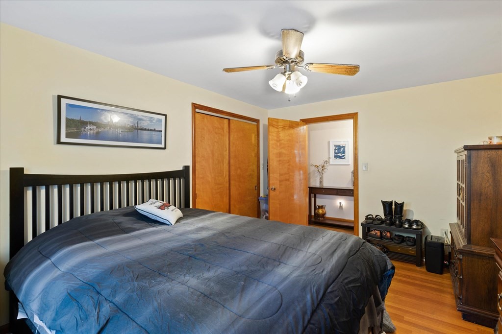 16 Main Street Sturbridge, MA 01566 - Photo 17 of 39 a bedroom with a bed and a chandelier