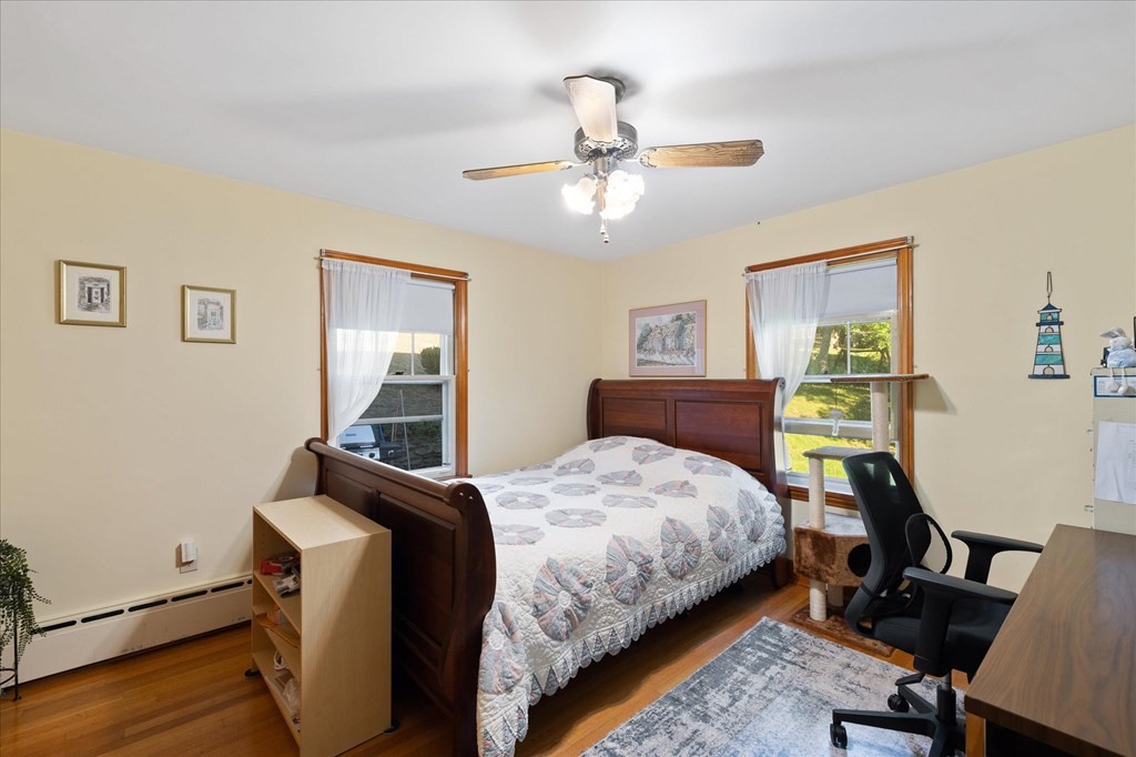 16 Main Street Sturbridge, MA 01566 - Photo 18 of 39 a bedroom with a bed and wooden floor