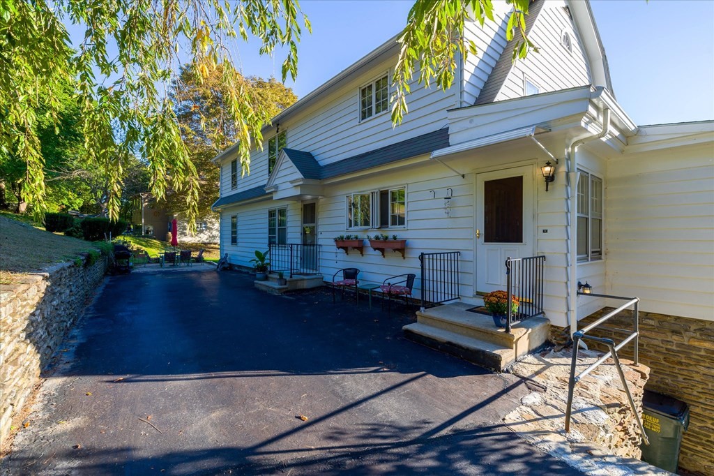 16 Main Street Sturbridge, MA 01566 - Photo 30 of 39 a front view of house with yard and trees in the background