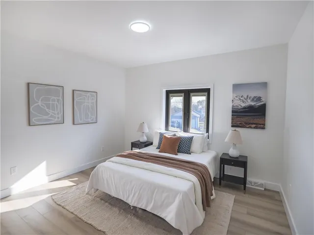 a bedroom with a large bed and a window