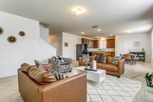 a living room with furniture kitchen view and a table