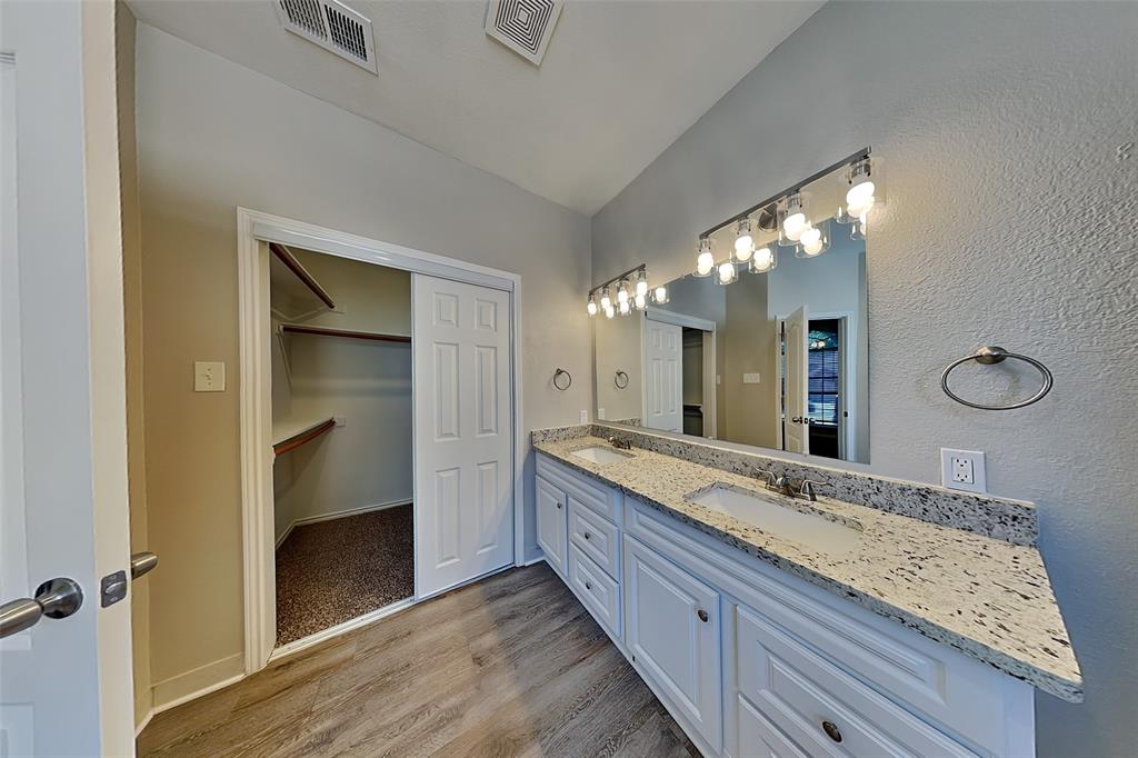 806 Kipling Drive Allen, TX 75002 - Photo 12 of 19 a bathroom with a granite countertop sink a large mirror and a shower