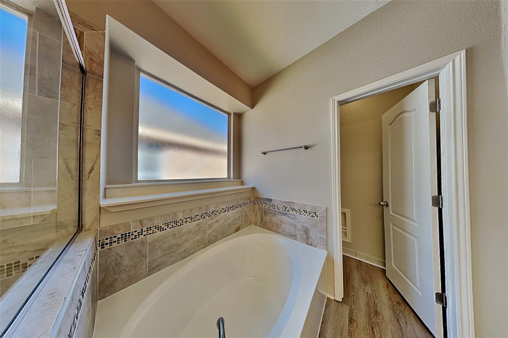 806 Kipling Drive Allen, TX 75002 - Photo 13 of 19 a bathroom with a bathtub and a shower