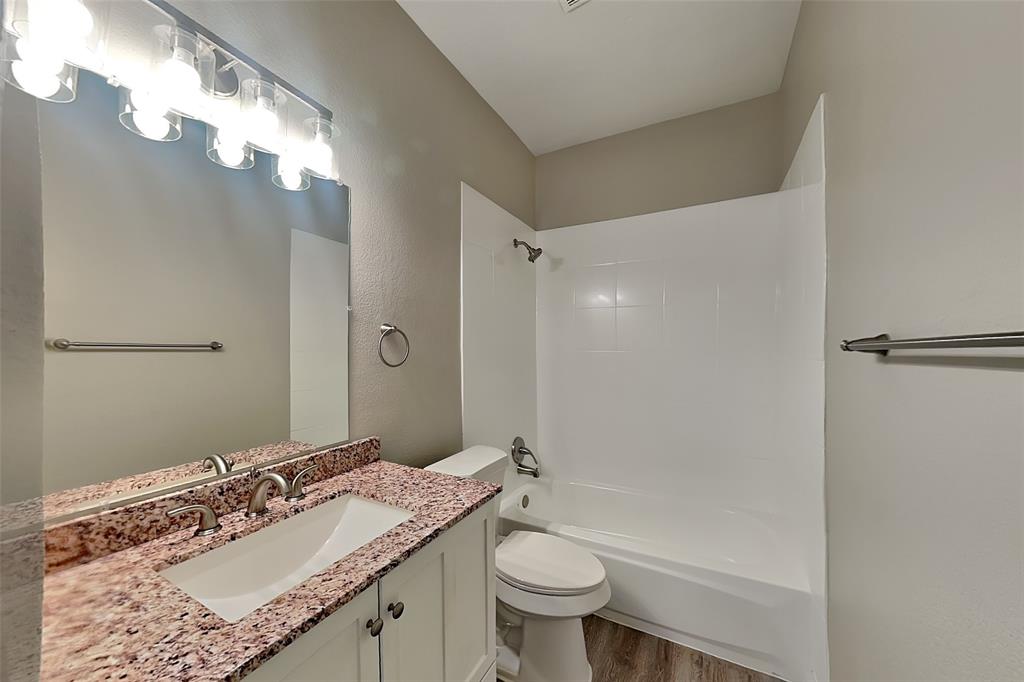 806 Kipling Drive Allen, TX 75002 - Photo 17 of 19 a bathroom with a granite countertop sink mirror vanity and toilet